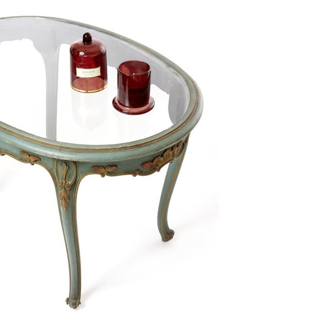 Lacquered coffee table. Louis XV Baroque Venetian style, lightblue with alabaster top and gilded carved leaves....