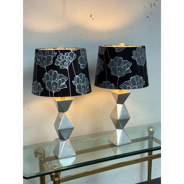 Design Plus Gallery presents a Pair of Geometric Silver Table Lamps. Each lamp has a sculptural stacked geometric base in...