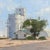 Untitled by Stephanie Hartshorn | Oil on wood panel depicting a rural scene with silos and a house. For Sale