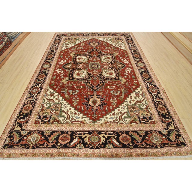 A traditional Heriz Ziegler rug, hand-knotted with fine wool and natural dyes. This area rug features a central geometric...