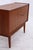 Vintage teak chest of drawers from the 1960s with a clean, straight design and beautiful wood grain. The raised shape with...