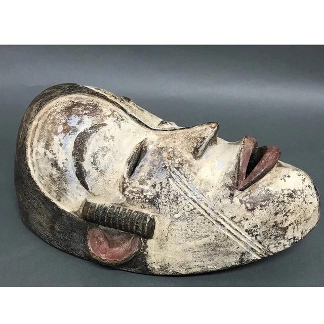 African Antique Bacongo Mask. The dimension is 13 inches high x 9 inches wide. Remaining pigments of blue, red, white,...