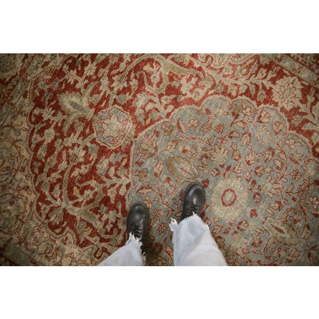 :: Heriz-area made oversized scalloped center medallion adorned at either end by double tiered finials ending in a trefoil...