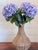 Bring effortless elegance into any space with this handcrafted arrangement featuring lush lavender hydrangeas artfully...