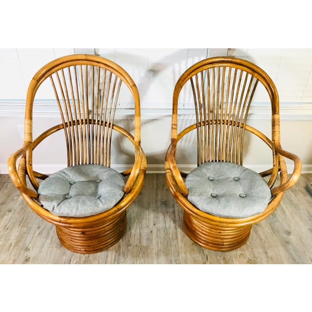 Chic and stylish 1970's bamboo rattan chairs with the original glossy sheen in the style of Paul Frankl, circa the 1970s....