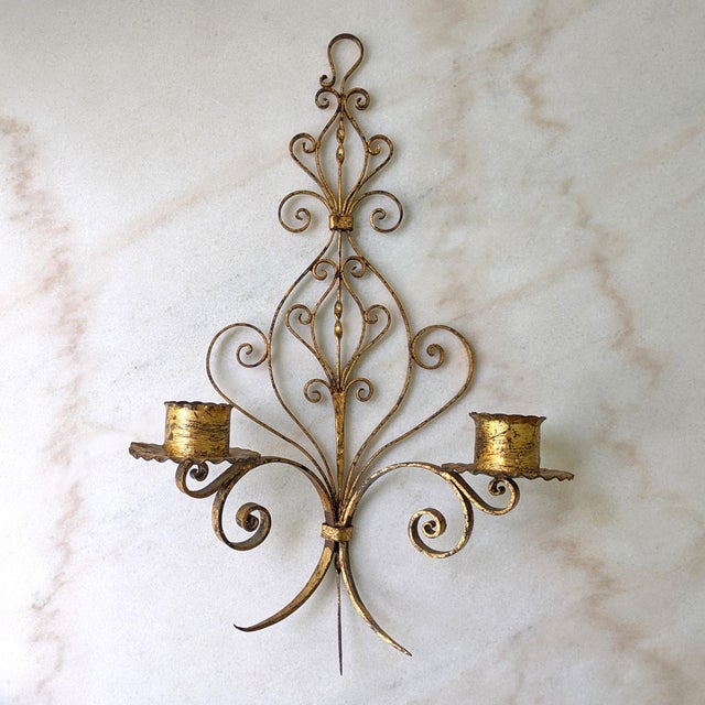 Large vintage Italian style gilt wall-hanging sconce with scrolling flourshes and two candle holders. Two sconces...