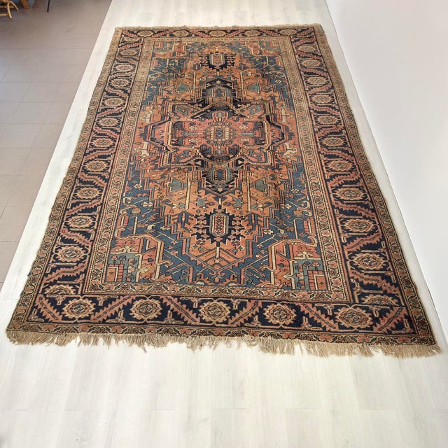 7’ 8” x 11’ 5” Beautiful Vintage Persian Heriz Serapi style room size rug from the early 1900s. Muted blues, camel and...