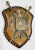 Vintage souvenir style coat of arms with medieval crest, dual swords, two lions and shield. Wall mounted and set on...
