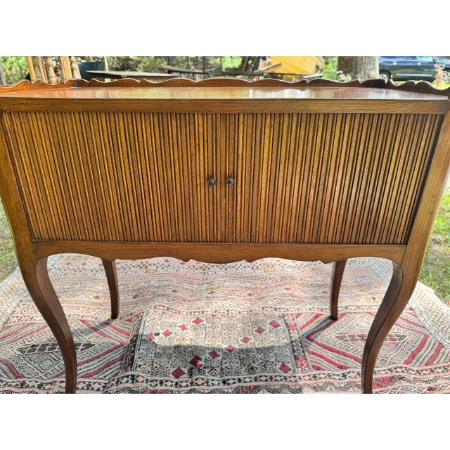A charming French Provincial nightstand or side table in the Louis XV revival style, crafted in solid oak with a warm...