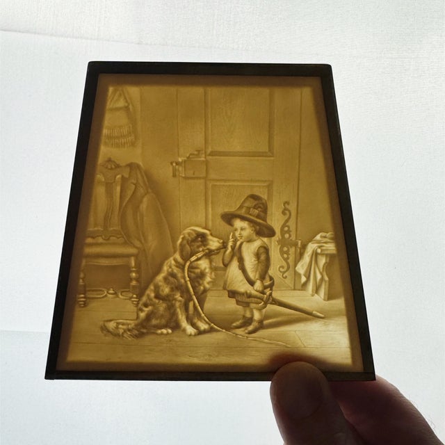 Charming vintage ceramic lithophane plaque featuring a beautifully detailed sepia-toned scene of a young child in a hat...