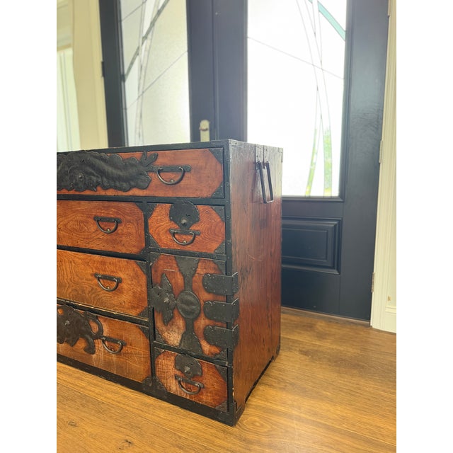 A remarkable and highly decorative Japanese tansu chest dating to the late Meiji period, circa 1880–1905, crafted from...