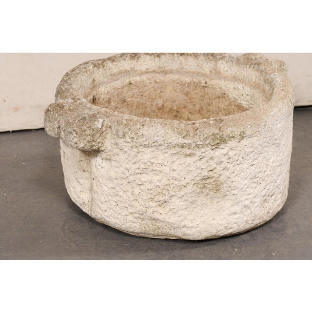 A Spanish hand-carved stone vessel with handles, from the 19th century. This antique vessel from Spain has a round shape,...