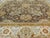 An attractive rug with floral decoration on a light chocolate brown field within ivory vanilla border. Hand spun wool pile...
