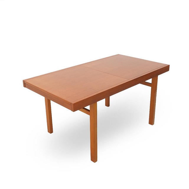 Italian manufacturing table produced in the 1960s. Legs in solid wood. Top in veneered wood, extendable via central...