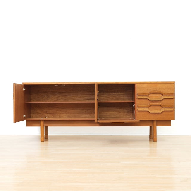 This vintage mid-century extending dining table was produced by Jentique in the 1960s. Made of teak, this extending dining...