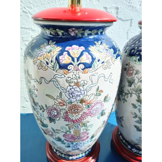 A beautiful pair of vintage Chinoiserie table lamps. The lamps feature a pretty floral ceramic body in shades of pink,...