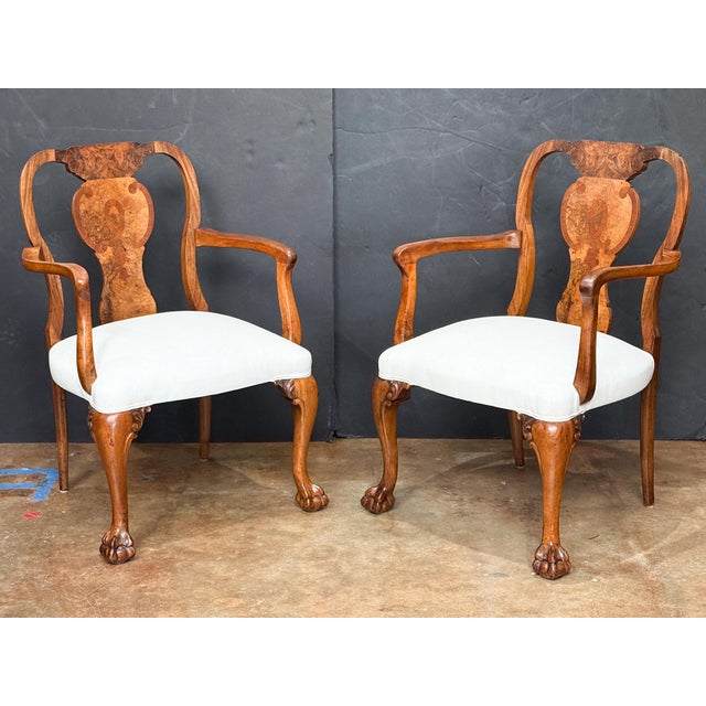 A fine pair of English walnut armchairs in the Queen Anne style - each chair featuring a burl walnut vase-shaped splat and...