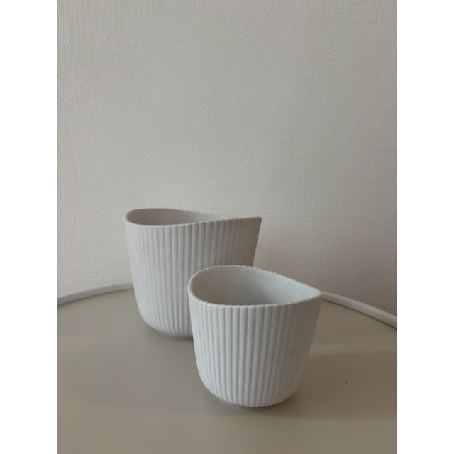 A set of two “Vinda” vases designed by Stig Lindberg for Gustavsberg in the 1950s. Made of cream-white glazed stoneware,...
