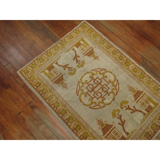 Very rare matching pair of antique khotans with one measuring 2'8" x 3'8" and the other measuring 2'8" x 3'9".