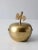 This is a mid 20th century figurative brass box. Shaped like an apple, the jar opens in half with a nested lid.