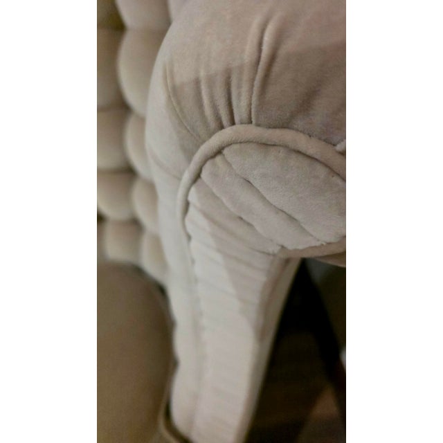 Designed by Ebanista. Handcrafted in Southern California. Box tufted lounge chair with pleated arm detail. Exposed legs in...
