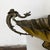 An impressive antique silverplate centerpiece bowl featuring striking dragon handles, ornate shell feet, and decorative...