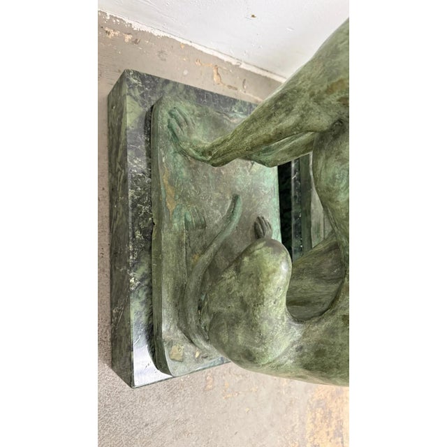 Fine pair of cast bronze greyhound figures seated upright, each with realistic musculature and elegant proportion. Mounted...