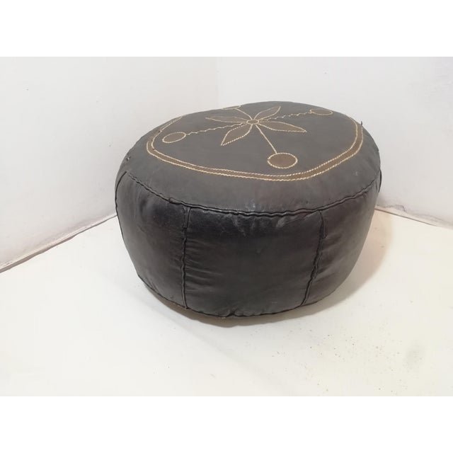 Moroccan Berber Arab footstool in decorated and stitched cowhide. Fair condition. One unstitched seam is visible in the...