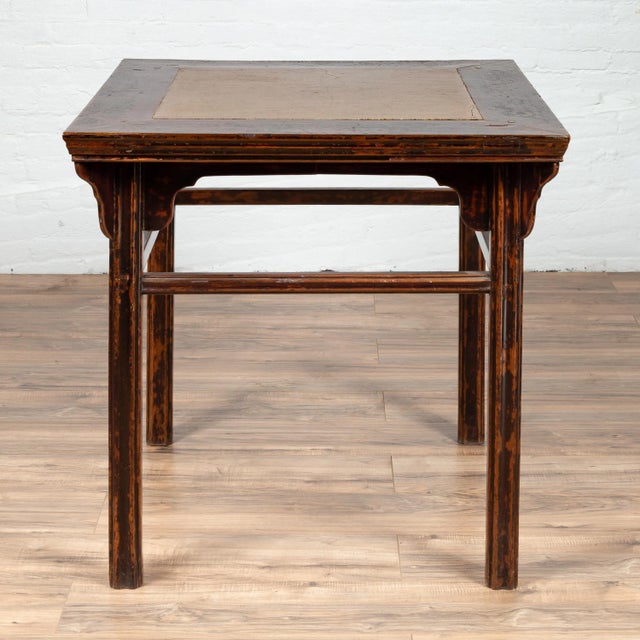 A Chinese 19th century elmwood center hall table with Ming dynasty 15th or 16th century courtyard stone inset. Born in...