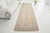 This is a vintage Turkish Oushak rug from the Mid 20th Century. The piece was hand-knotted.