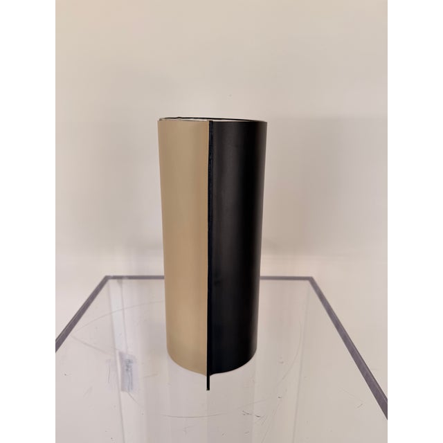 Contemporary leather vase featuring a sleek glass cylindrical vase wrapped in removable smooth leather sleeve with refined...