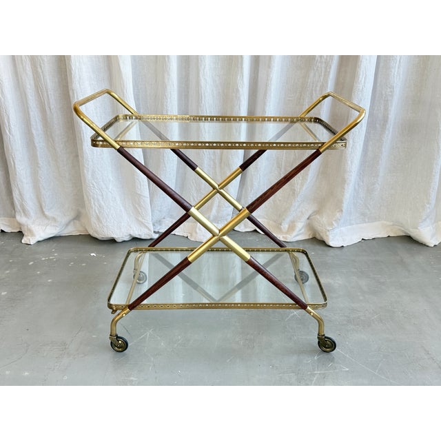 Spectacular Italian mid century wood and brass serving bar cart by Cesare Lacca, 1950s. Beautiful combination of brass and...