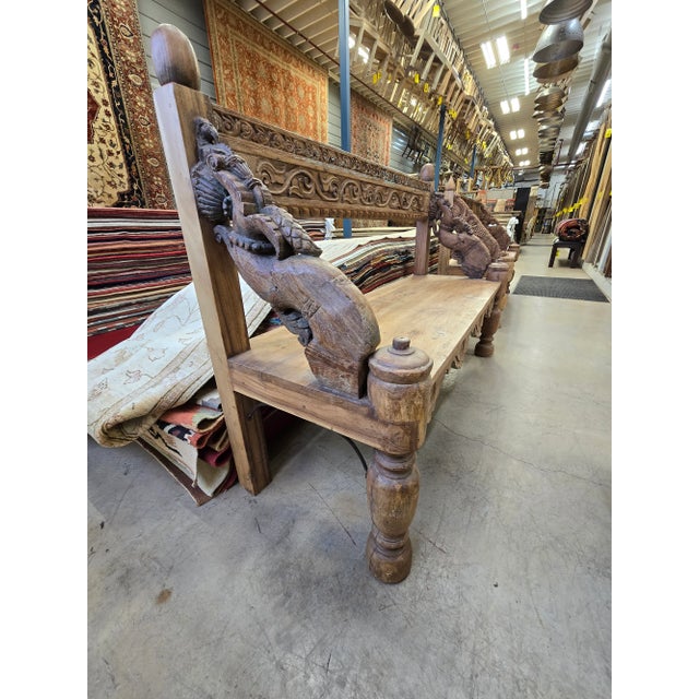 This reclaimed solid wood bench with a floral carving design is a unique and antique piece of furniture. Handmade in...