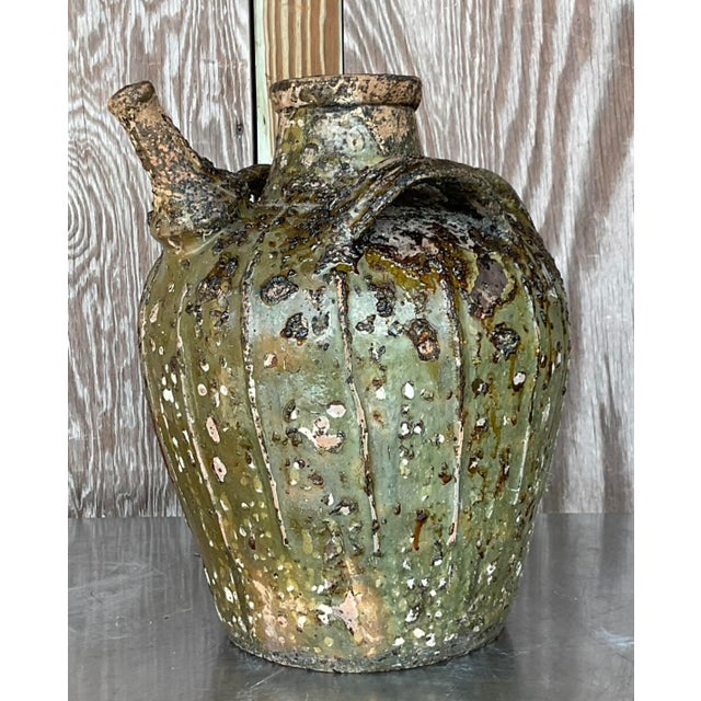 Earthen Elegance: The Vintage Boho Patinated Matte Glazed Ceramic Urn exudes American style with its rustic allure and...