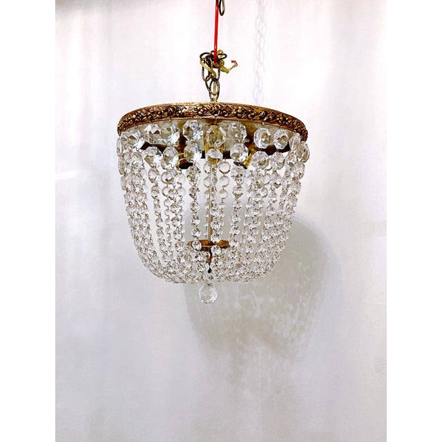 Italian Basket chandelier with bronze rim and 30% led graduated octagon chain. It has 3 candelabra base sockets that each...