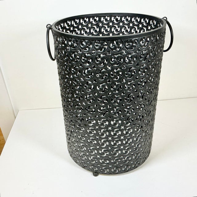 Italian design can transcend time even for an item like a Hamper. This black metal pierced Hamper features and open sheet...