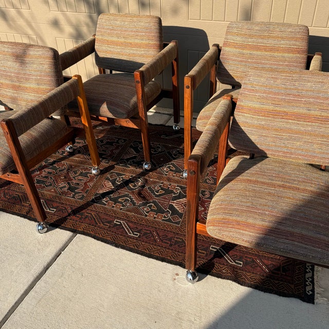 Beautiful mid century solid rosewood occasional chairs on castors by Sergio Rodrigues. THESE are the chairs you’d want to...