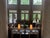 Two beautiful Marge Carson 118”W x 54”D x 34” H brown with hint of gold’ sofa’s with decorative trim and antique brass...