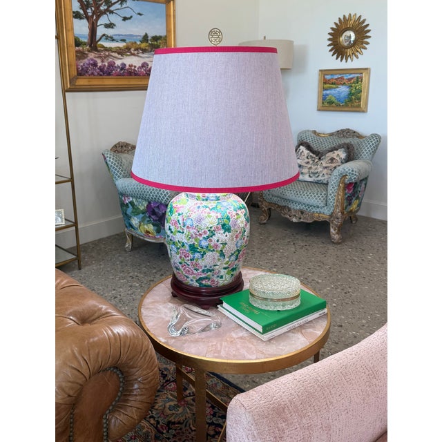 This lamp's base is an elegant Mille Fleurs(Thousand Flowers) porcelain ginger jar, adorned with a vibrant profusion of...