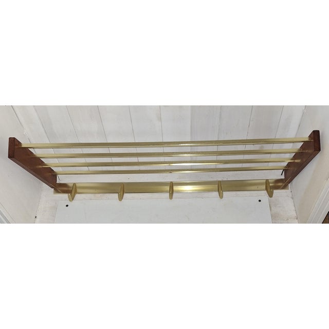 Vintage Wall-Mounted Coat Rack in Teak Wood and Gold-Anodised Aluminium, 1970s, in Very Good conditions. Designed 1970 to...