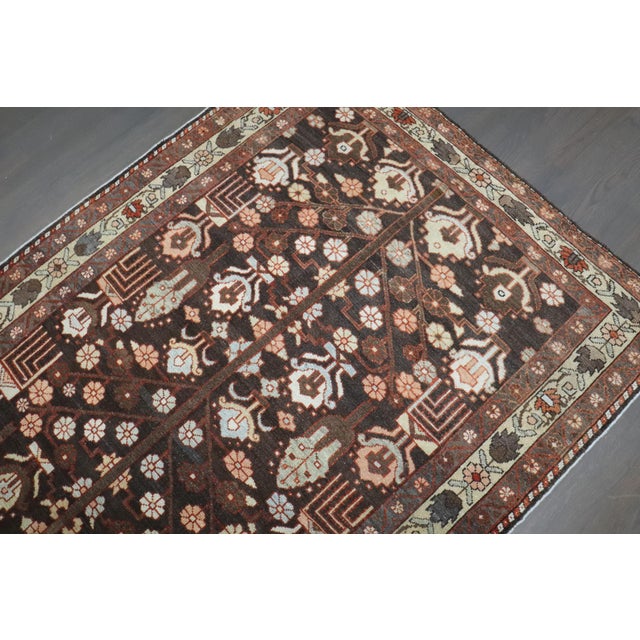 An early 20th Century Kurd Persian Bakhtiari in a predominant dark brown with a tribal geometric design Details rug no....