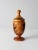 This vintage hand-carved wood jar features stylized botanical carvings that evoke tropical foliage, set against warm,...