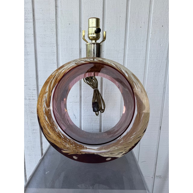 This one of a kind bold, tropical-inspired lighting piece is made from thick, amethyst toned acrylic. It features a...