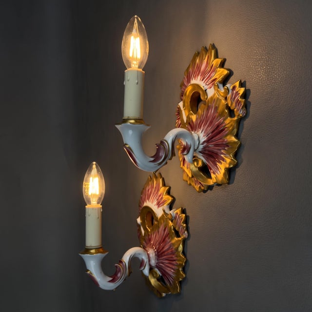 An elegant pair of single-light wall sconces in decorated porcelain, crafted by the prestigious p. Limoges france factory,...