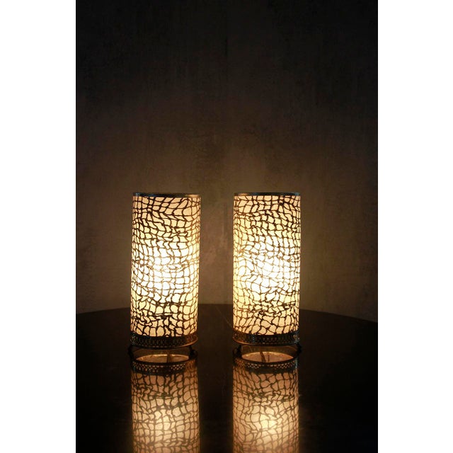 This elegant Moroccan-style table lamp showcases a crocodile-skin pattern, adding a touch of exoticism. The design is...