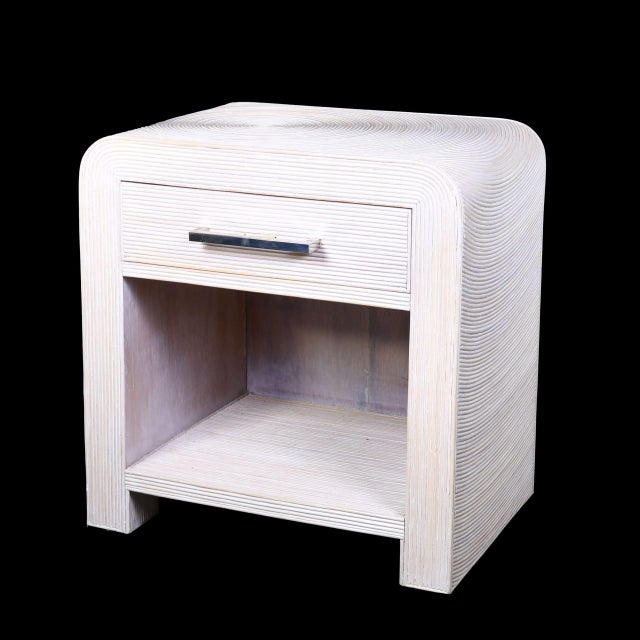 Pair of blonde Crespi-style nightstands crafted from pencil reed rattan. Each offers a single drawer plus an open shelf...
