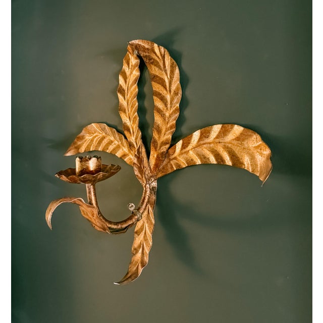 Vintage gilt iron Tole candle wall sconce featuring a palm frond motif. Holds one candle. Metal hang tag marked "Made in...
