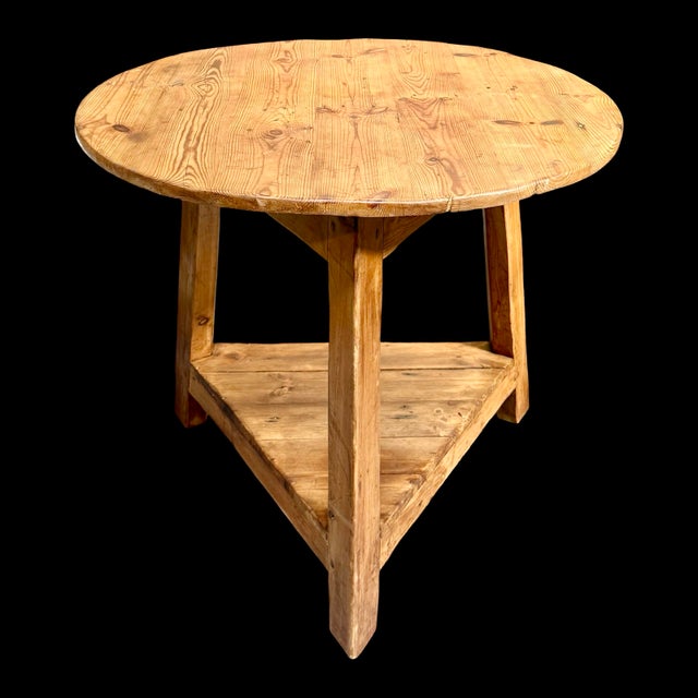 This antique pine cricket table features the classic English three-legged design with a circular top and a triangular...