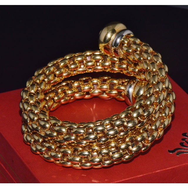 Authentic vintage FOPE solid 18K yellow and white gold double-wrap bracelet featuring bold, high-domed two-tone terminals....