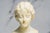 A refined example of early 20th-century neoclassical sculpture, this antique hand-carved marble bust dates to circa 1915...